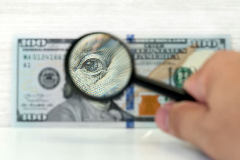 inspecting fake money