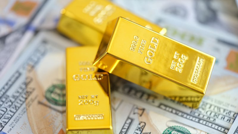 gold bars on dollar bills
