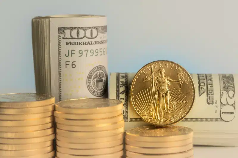 gold coins with $100 bills