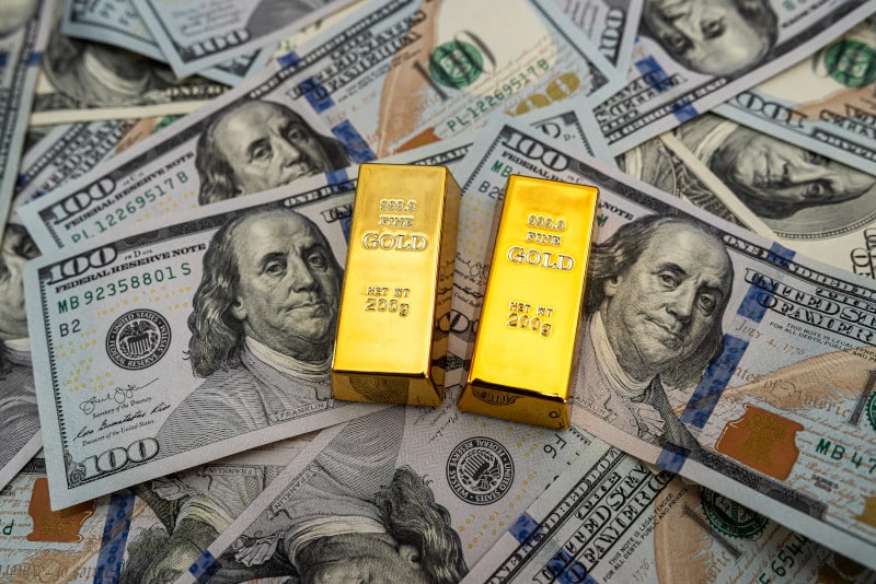 gold bars with $100 bills