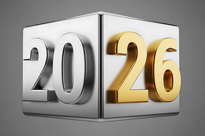 The year 2026 is displayed with silver and gold metallic numbers on a reflective silver cube