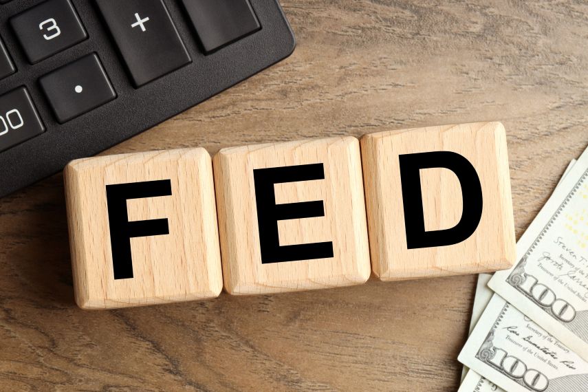 FED on Wood Table with Cash and Calculator